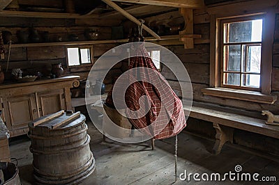 Cradle for the child and a barrel. Inside Tsipelevâ€™s house. Kostroma region. Editorial Stock Photo
